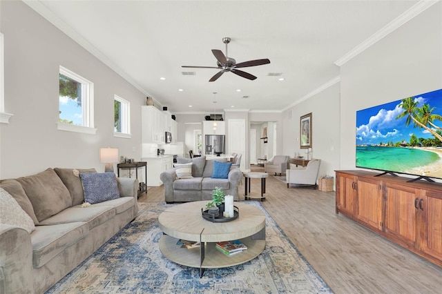 1821 Simonton Ave, Orlando, FL 32806 - living room featuring visible vents, light wood-type flooring, a ceiling fan, and ornamental molding