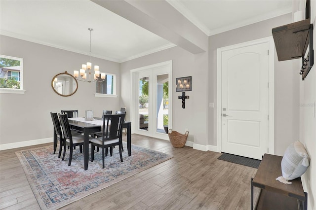 1821 Simonton Ave, Orlando, FL 32806 - dining room featuring a chandelier, crown molding, wood finished floors, and baseboards