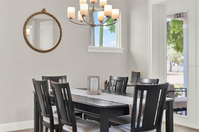 1821 Simonton Ave, Orlando, FL 32806 - dining area with baseboards, an inviting chandelier, and wood finished floors