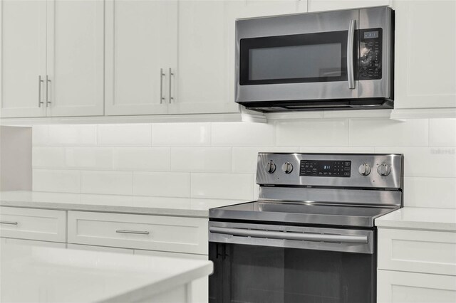 1821 Simonton Ave, Orlando, FL 32806 - kitchen featuring appliances with stainless steel finishes, light countertops, and backsplash