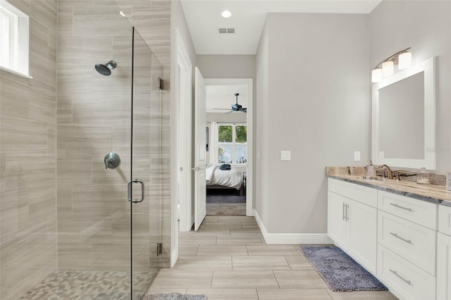 1821 Simonton Ave, Orlando, FL 32806 - bathroom featuring ceiling fan, vanity, visible vents, a stall shower, and baseboards