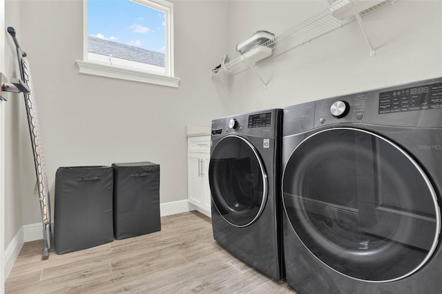 1821 Simonton Ave, Orlando, FL 32806 - clothes washing area with independent washer and dryer, light wood-style floors, baseboards, and cabinet space