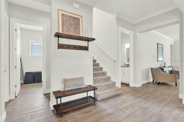 1821 Simonton Ave, Orlando, FL 32806 - foyer with stairway, light wood-type flooring, baseboards, ornamental molding, and visible vents
