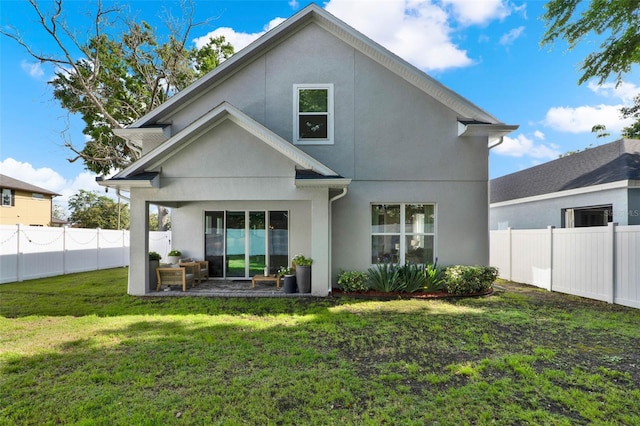 1821 Simonton Ave, Orlando, FL 32806 - back of house featuring a fenced backyard, stucco siding, and a lawn