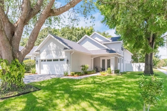 1821 Simonton Ave, Orlando, FL 32806 - traditional-style house with an attached garage, stucco siding, fence, and a front lawn