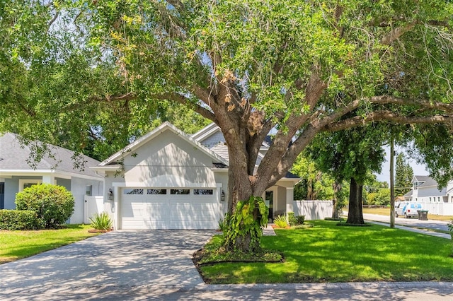 1821 Simonton Ave, Orlando, FL 32806 - view of front facade with a front yard, an attached garage, fence, and concrete driveway