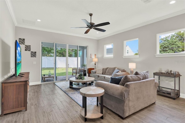 1821 Simonton Ave, Orlando, FL 32806 - living area with crown molding, ceiling fan, light wood-style floors, and baseboards