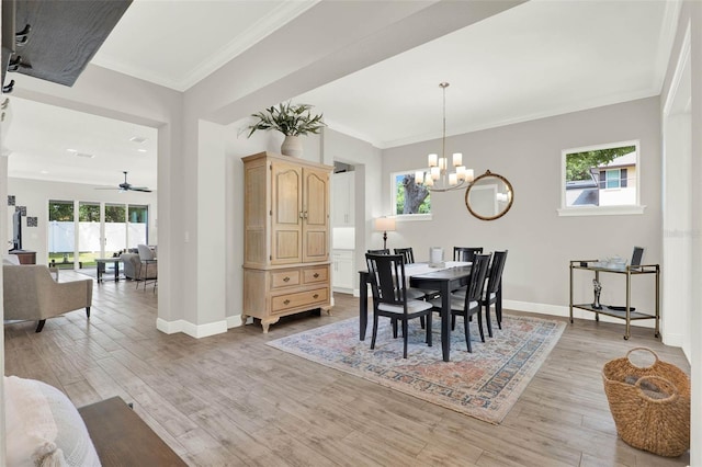 1821 Simonton Ave, Orlando, FL 32806 - dining area featuring light wood finished floors, baseboards, ornamental molding, and ceiling fan with notable chandelier