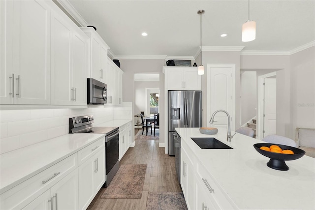 1821 Simonton Ave, Orlando, FL 32806 - kitchen featuring decorative light fixtures, a sink, crown molding, stainless steel appliances, and decorative backsplash