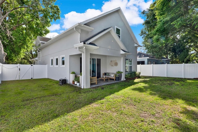 1821 Simonton Ave, Orlando, FL 32806 - rear view of property featuring a yard, a fenced backyard, stucco siding, and a gate