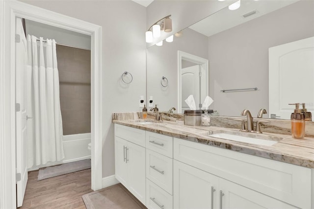 1821 Simonton Ave, Orlando, FL 32806 - bathroom featuring wood finished floors, a sink, visible vents, and double vanity
