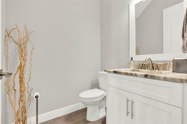1821 Simonton Ave, Orlando, FL 32806 - half bath with baseboards, wood finished floors, toilet, and vanity