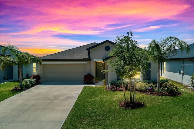 4094 San Clemente Ct, North Fort Myers, FL 33917 - ranch-style home with concrete driveway, roof with shingles, stucco siding, a garage, and a lawn