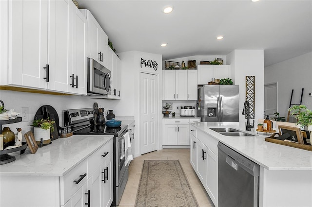 4094 San Clemente Ct, North Fort Myers, FL 33917 - kitchen featuring an island with sink, light tile patterned floors, recessed lighting, a sink, and stainless steel appliances