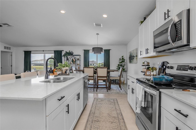 4094 San Clemente Ct, North Fort Myers, FL 33917 - kitchen featuring visible vents, white cabinets, a sink, a center island with sink, and stainless steel appliances