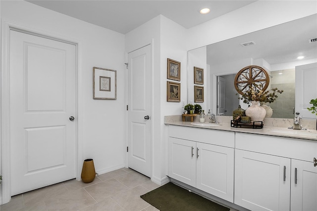 4094 San Clemente Ct, North Fort Myers, FL 33917 - full bath with tiled shower, double vanity, a sink, and visible vents