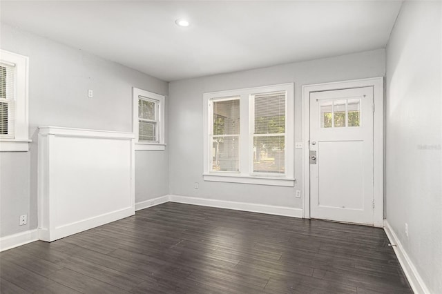 foyer with baseboards and dark wood-style floors