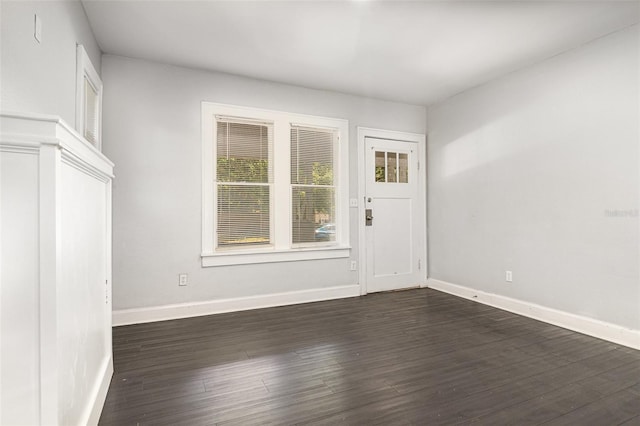 interior space with baseboards and dark wood-style floors