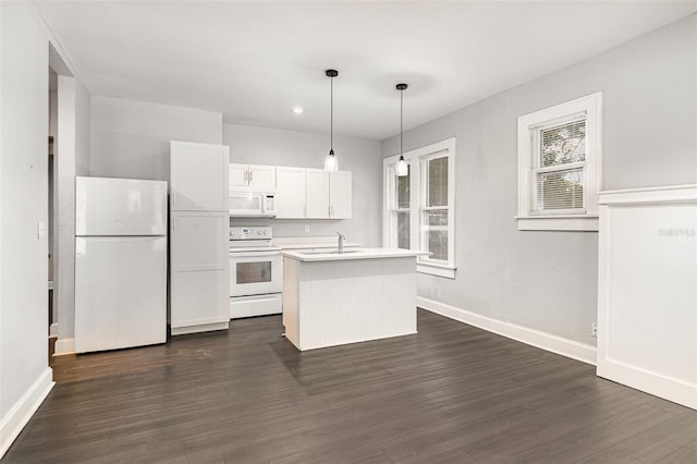 kitchen with white appliances, light countertops, an island with sink, baseboards, and dark wood-style floors
