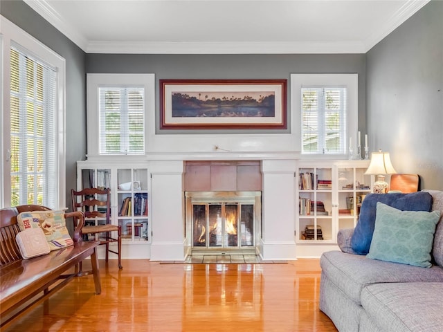 811 Laurel Ave, Orlando, FL 32803 - living area with wood finished floors, a tiled fireplace, healthy amount of natural light, and crown molding
