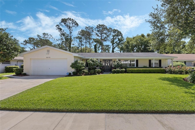 3015 Dawley Ave, Orlando, FL 32806 - ranch-style home featuring a garage, a front yard, driveway, and stucco siding