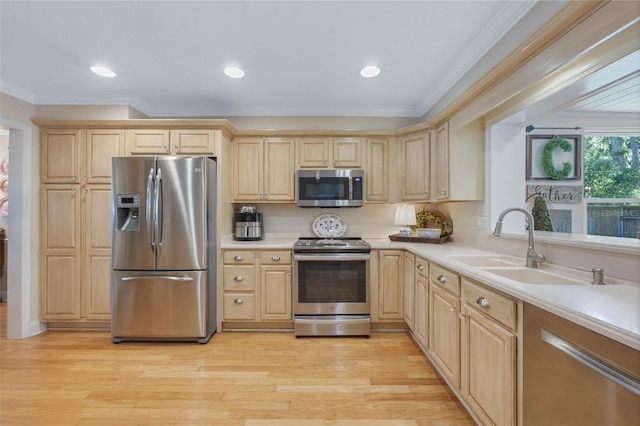 3015 Dawley Ave, Orlando, FL 32806 - kitchen featuring stainless steel appliances, light brown cabinets, light wood finished floors, light countertops, and ornamental molding