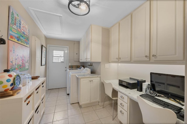 3015 Dawley Ave, Orlando, FL 32806 - washroom featuring washer and dryer, light tile patterned floors, a desk, and cabinet space
