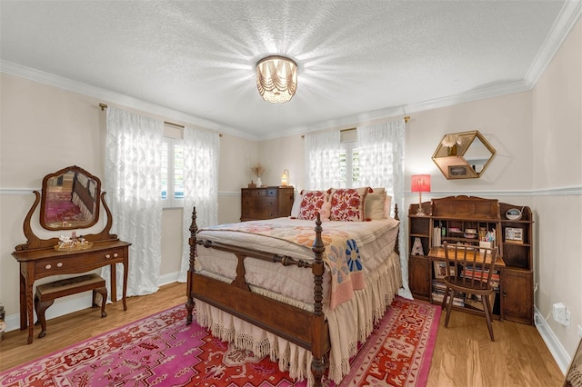3015 Dawley Ave, Orlando, FL 32806 - bedroom with wood finished floors, a textured ceiling, and crown molding