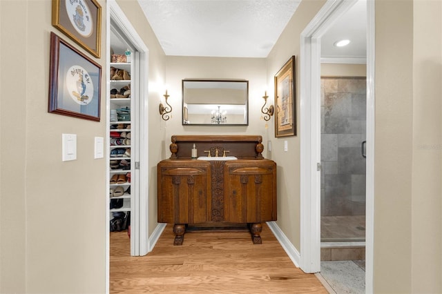 3015 Dawley Ave, Orlando, FL 32806 - full bathroom featuring wood finished floors, a stall shower, a walk in closet, and vanity