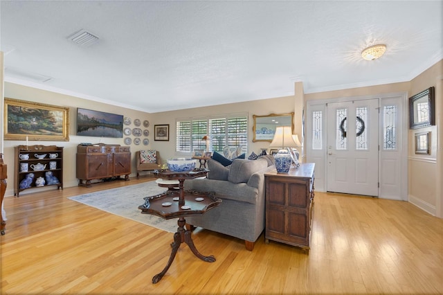 3015 Dawley Ave, Orlando, FL 32806 - living room featuring light wood-style floors and crown molding