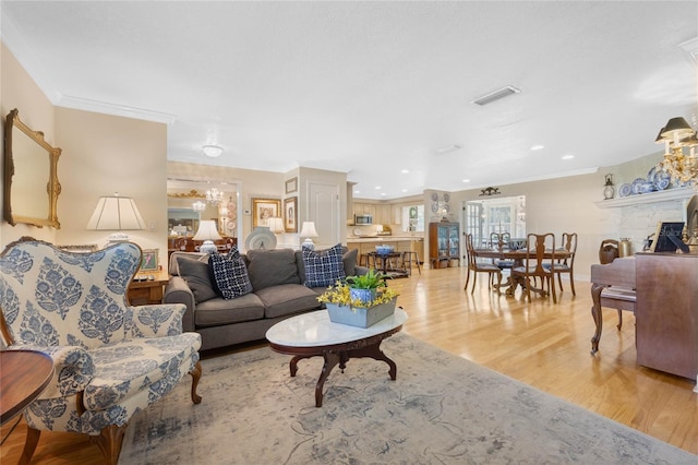 3015 Dawley Ave, Orlando, FL 32806 - living area featuring light wood-type flooring, ornamental molding, a chandelier, and recessed lighting