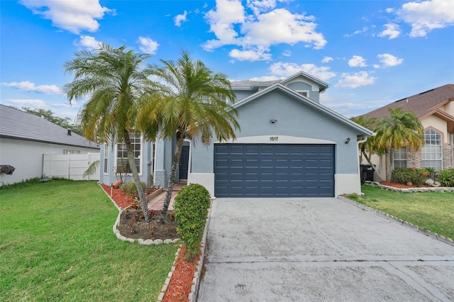 1517 Abberton Dr, Orlando, FL 32837 - view of front of home with a garage, stucco siding, driveway, and a front lawn