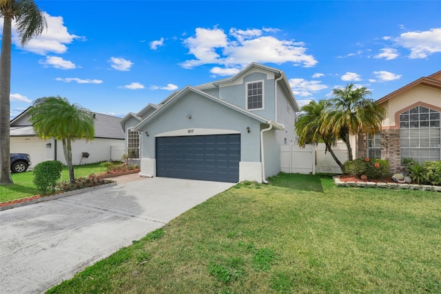 1517 Abberton Dr, Orlando, FL 32837 - view of front of home featuring stucco siding, driveway, a front yard, a garage, and fence