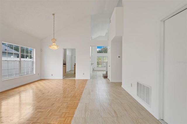 1517 Abberton Dr, Orlando, FL 32837 - empty room with visible vents, high vaulted ceiling, plenty of natural light, and a notable chandelier
