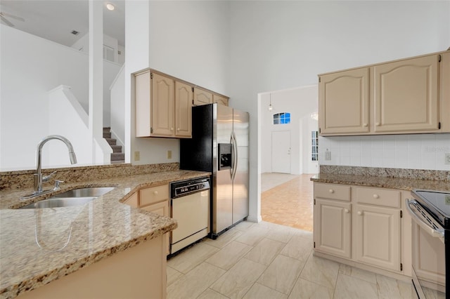 1517 Abberton Dr, Orlando, FL 32837 - kitchen with stainless steel fridge with ice dispenser, light stone counters, range with electric stovetop, dishwasher, and a sink