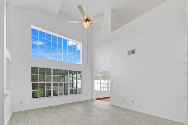 1517 Abberton Dr, Orlando, FL 32837 - spare room with visible vents, baseboards, a ceiling fan, and a towering ceiling