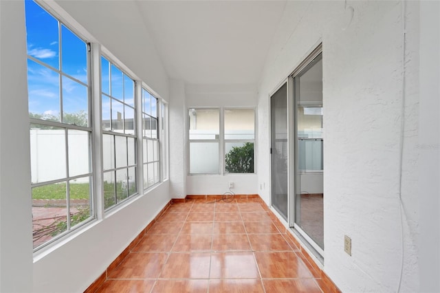 1517 Abberton Dr, Orlando, FL 32837 - unfurnished sunroom featuring tile patterned floors, plenty of natural light, and a textured wall