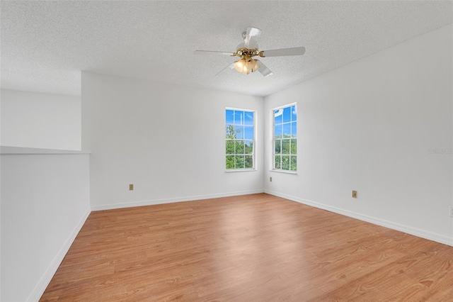 1517 Abberton Dr, Orlando, FL 32837 - unfurnished room with light wood-type flooring, ceiling fan, baseboards, and a textured ceiling