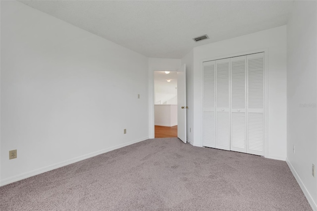 1517 Abberton Dr, Orlando, FL 32837 - unfurnished bedroom with carpet, visible vents, a closet, and baseboards