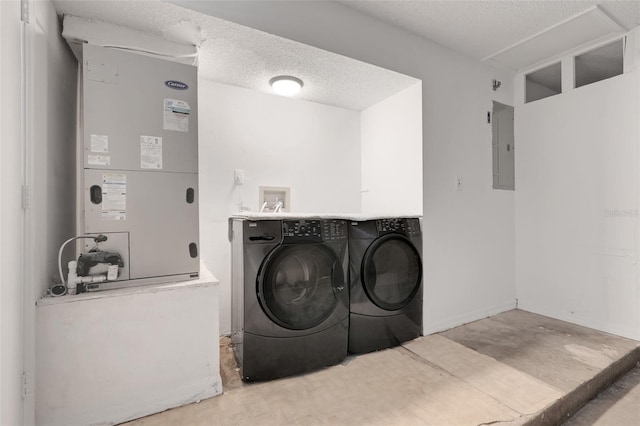 1517 Abberton Dr, Orlando, FL 32837 - washroom featuring heating unit, washer and dryer, electric panel, and a textured ceiling