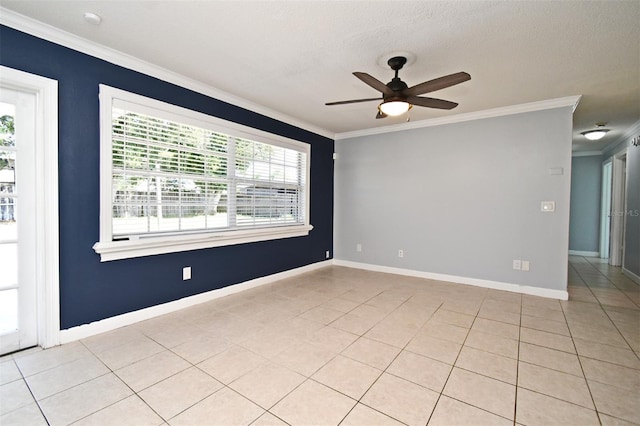 spare room with ceiling fan, light tile patterned floors, a textured ceiling, ornamental molding, and baseboards