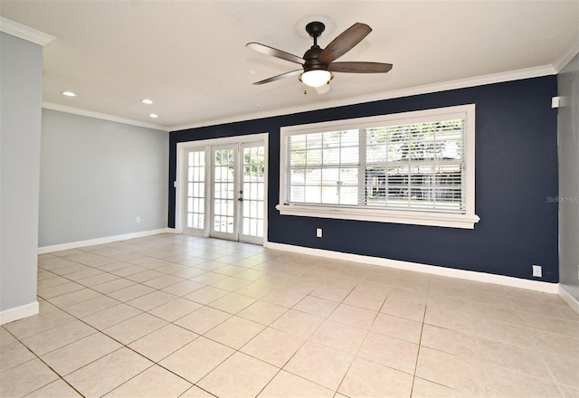 empty room featuring crown molding, baseboards, and plenty of natural light
