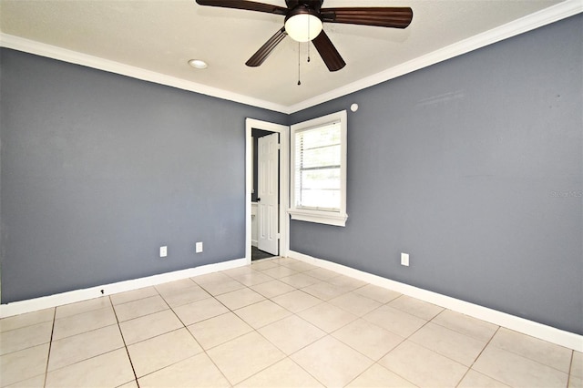 spare room featuring crown molding, ceiling fan, baseboards, and tile patterned floors