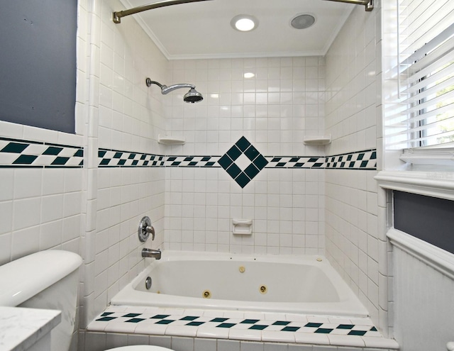 bathroom with crown molding, a combined bath / shower with jetted tub, vanity, and toilet