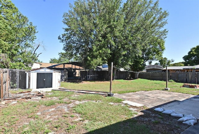 view of yard featuring an outbuilding, a fenced backyard, and a shed