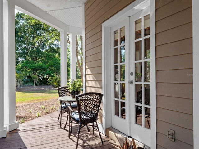 6037 Lake Erie Rd, Groveland, FL 34736 - wooden terrace with covered porch and french doors