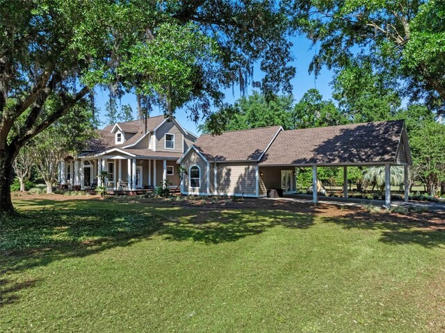 6037 Lake Erie Rd, Groveland, FL 34736 - view of front facade with a front lawn, a carport, and a porch