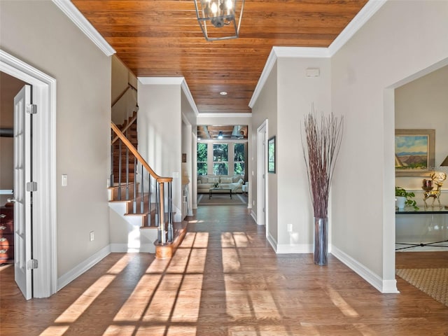 6037 Lake Erie Rd, Groveland, FL 34736 - entrance foyer featuring wood ceiling, crown molding, stairs, wood finished floors, and baseboards