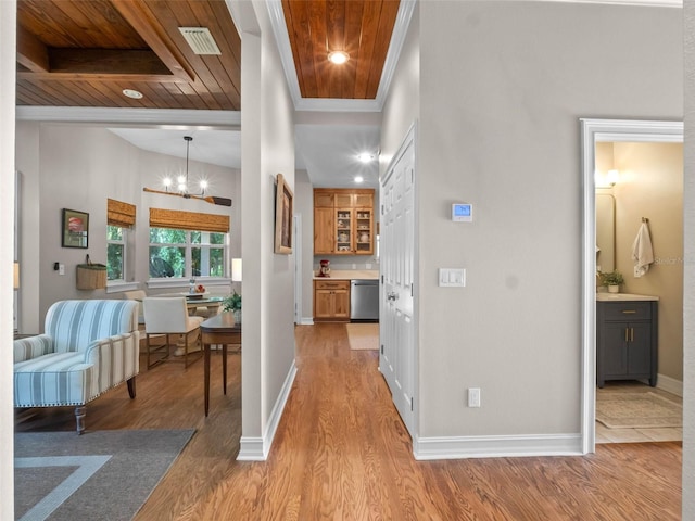 6037 Lake Erie Rd, Groveland, FL 34736 - hallway with wood ceiling, light wood-style flooring, a chandelier, baseboards, and ornamental molding