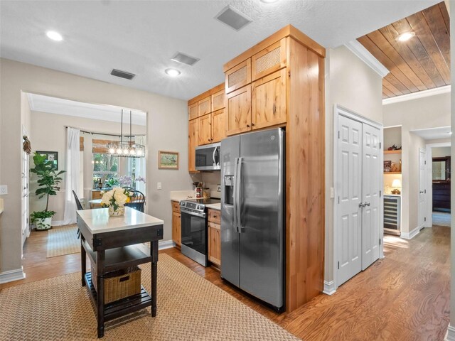 6037 Lake Erie Rd, Groveland, FL 34736 - kitchen featuring appliances with stainless steel finishes, wine cooler, light wood-style flooring, recessed lighting, and baseboards